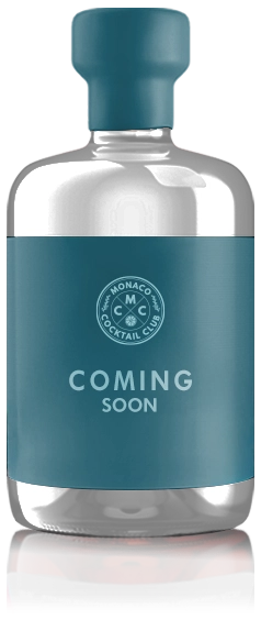A stylized bottle for Monaco Cocktail Club with a dark teal label and cap. The label features the brand's logo and the words 'Coming Soon' to tease a new product release.